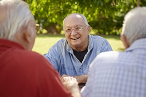 Three elderly men sitting outside